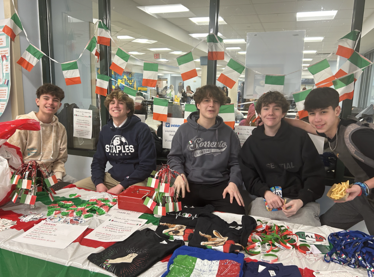 Latin club presidents and members sell Italian themed merchandise on March 14. Italian students also created posters with language trivia that hang in the hallways. 
