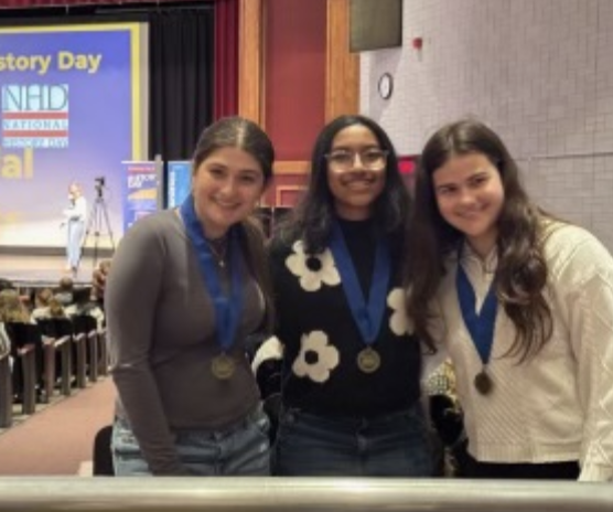 Zara Saliba ’26, Uma Choudhury ’26 and Caroline Banks ’26 at the Connecticut state National History Day competition at Central Connecticut State University. Their tri-fold poster on the medical and ethical impacts of HeLa cells earned them first place in the Senior Division Group Exhibit category.