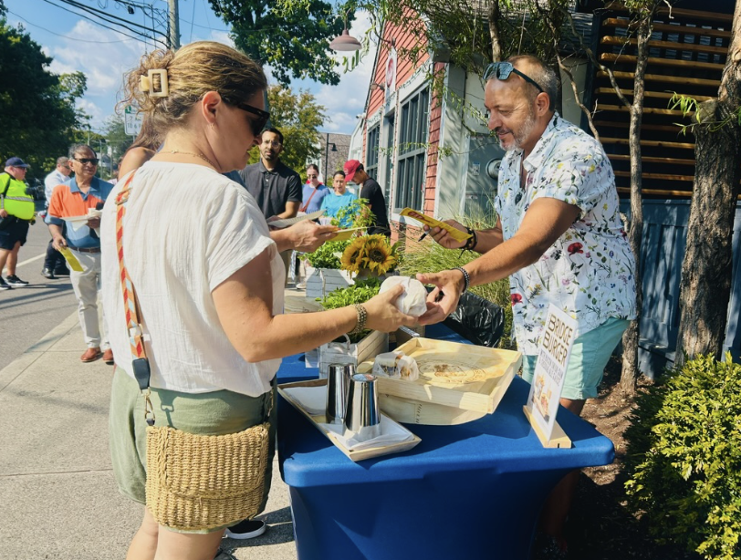 Order up! New restaurant, The Bridge, hands out full sized burgers to Slice of Saugatuck attendees. 