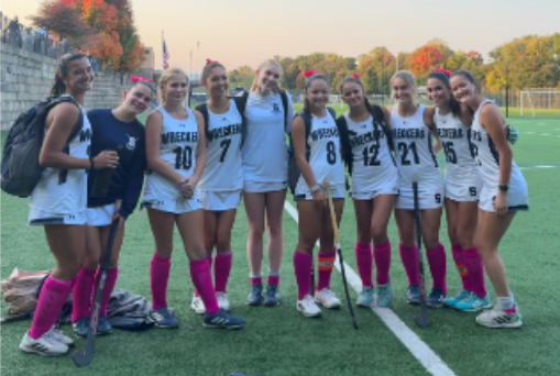 Players from the field hockey team pose for a photo after their victory against Darien, winning 5-2.