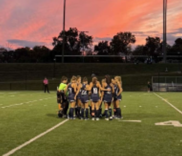 The varsity girls’ field hockey huddles up before a regular season matchup against Norwalk on Oct. 9. The team prevailed with a final score of 4-0. 